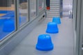 Blue pots on conveyor belt of plastic injection molding machine at exhibition