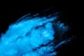 Blue powder explode cloud on black background. Launched blue dust particles splash on  background Royalty Free Stock Photo
