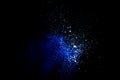 Blue powder explode cloud on black background. Launched blue dust particles splash on background Royalty Free Stock Photo