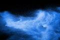 Blue powder explode cloud on black background. Launched blue dust particles splash