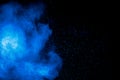 Blue powder explode cloud on black background.Launched blue dust particles splash on background Royalty Free Stock Photo