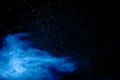 Blue powder explode cloud on black background.Launched blue  dust particles splash on background Royalty Free Stock Photo