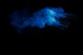 Blue powder explode cloud on black background.Launched blue dust particles splash on background Royalty Free Stock Photo