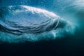 Blue powerful wave crashing in ocean. Underwater barrel wave and air bubbles