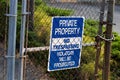 Blue private property no trespassing sign on a chain link fence Royalty Free Stock Photo