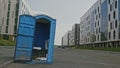 Blue public toilet at empty street of innopolis city, close up