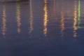 Blue or purple background with bridge lights reflection in river water at night. Soft focus Royalty Free Stock Photo