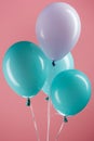 Blue and purple colorful decorative festive balloons on pink background. Royalty Free Stock Photo