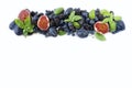 Blue and purple food. Group of fresh fruits and berries with basil`s on a white background. Royalty Free Stock Photo