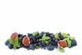 Blue and purple food. Group of fresh fruits and berries with basil`s on a white background. Royalty Free Stock Photo