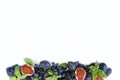 Blue and purple food. Group of fresh fruits and berries with basil`s on a white background. Royalty Free Stock Photo