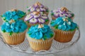 Blue and Purple frosted cupcakes decorated with gold dust