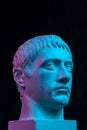 Blue purple gypsum copy of ancient statue of Germanicus Julius Caesar head for artists isolated on black background