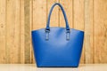 Blue purse on wood background