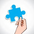 Blue puzzle piece on hand Royalty Free Stock Photo