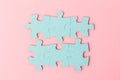 Blue puzzle pieces with empty space for your text and design on pink background Royalty Free Stock Photo