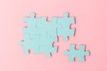 Blue puzzle pieces with empty space for your text and design on pink background Royalty Free Stock Photo