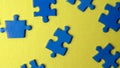 Scattered puzzle pieces on colored background