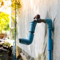 Blue PVC water pipes and tap for opening and closing. Royalty Free Stock Photo