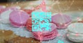 Blue QR code with a red floating web of connections over pink macaronies lying on a table Royalty Free Stock Photo