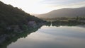 Blue quiet lake with green surrounding mountains.