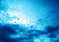 Blue rain drops on window glass background Royalty Free Stock Photo