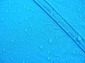 Blue rainproof tent sheet with morning rain drops Royalty Free Stock Photo