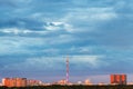 Blue rainy clouds over illuminated by sunset city Royalty Free Stock Photo