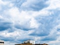 Blue rainy clouds over urban houses on spring Royalty Free Stock Photo