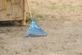 Blue rake for dry leaves and litter in the home garden