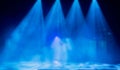 Blue rays of light from the spotlights through the smoke on the stage. Theatrical performance. Defocused abstract image Royalty Free Stock Photo