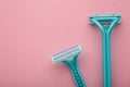 Blue razors for hair removal on pink background Royalty Free Stock Photo