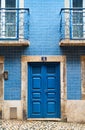 A blue rectangle wood door with the number 13 on a brick facade Royalty Free Stock Photo