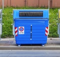 Blue recycling container on the street