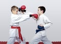 With blue and red belt boys train paired exercises karate