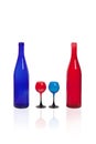 Blue and red bottle with glasses of the same color.