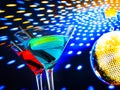 Blue and red cocktail with golden sparkling disco ball background with space for text Royalty Free Stock Photo