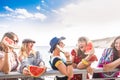 Blue and red colours image of group of females friends stay together and have fun in the summer eating a watermelon. smiles and