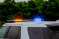 Blue and red flashing sirens of police car during the roadblock Royalty Free Stock Photo