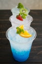 Blue Red Green Italian Soda Cold Beverage and Lemon Strawberry Kiwi Fruit Portrait Royalty Free Stock Photo