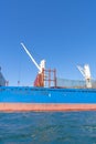 Blue and red hull of ship with white crane 1 Royalty Free Stock Photo