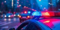 Blue and red light flasher atop of a police car. City lights on the background Royalty Free Stock Photo