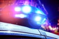 Blue and red light flasher of a patrol police car at night. Police force department in full activity with turned on lights. Night Royalty Free Stock Photo