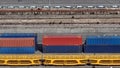 Blue and red metal cargo containers with yellow railway cargo platforms at the port customs in Europa