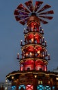 Blue and red night Christmas lights of traditional wooden carousel with catholic nativity scenes in Berlin Germany. Fairy tale Royalty Free Stock Photo