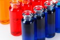 Blue, red and orange liquid in chemical lab test tubes on white background Royalty Free Stock Photo