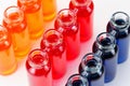 Blue, red and orange liquid in chemical lab test tubes on white background Royalty Free Stock Photo