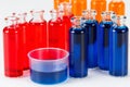 Blue, red and orange liquid in chemical lab test tubes on white background Royalty Free Stock Photo