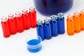 Blue, red and orange liquid in chemical lab test tubes on white background Royalty Free Stock Photo