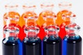 Blue, red and orange liquid in chemical lab test tubes on white background Royalty Free Stock Photo